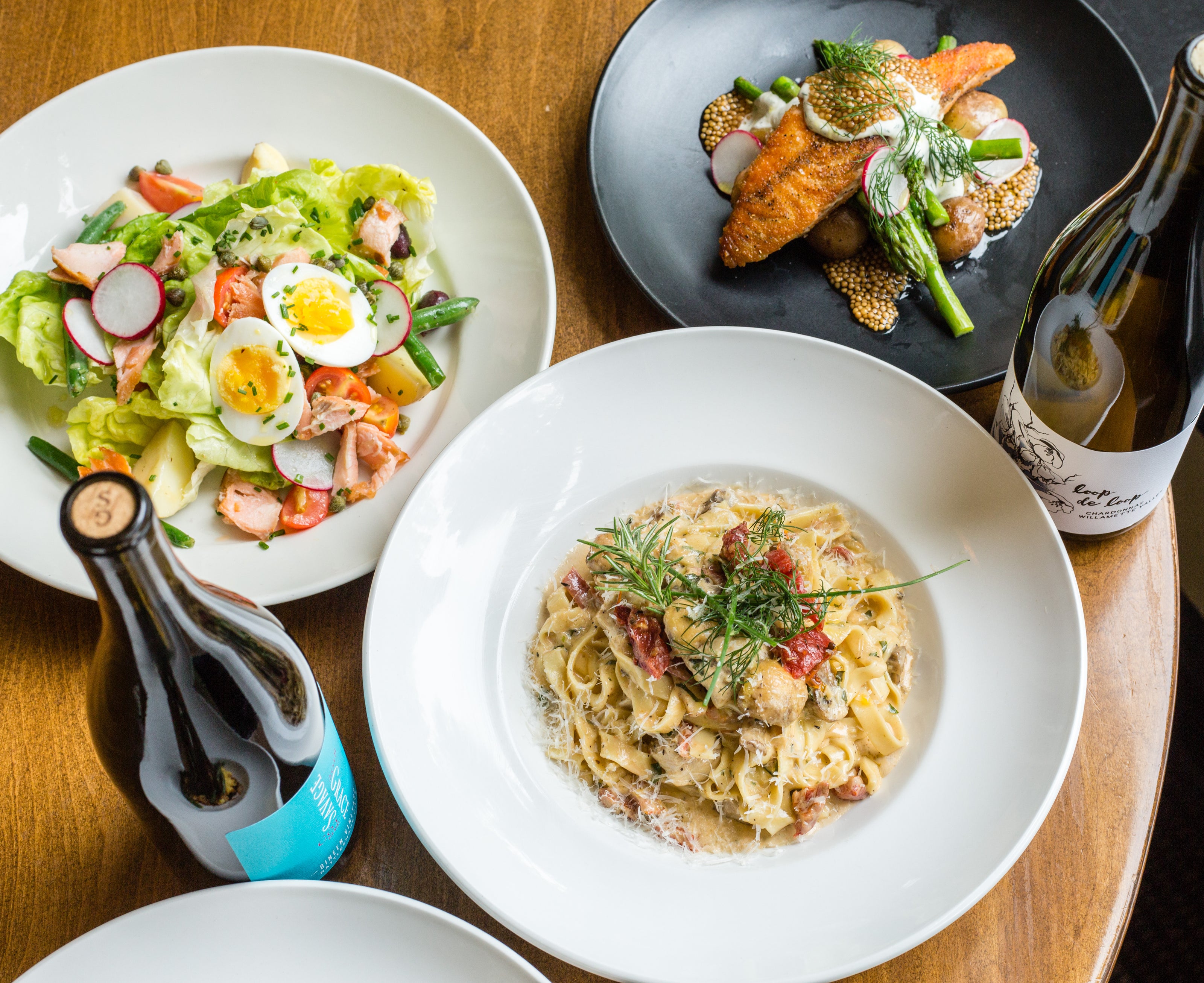 A spread of dishes on the Papa Haydn lunch and dinner menu, including creamy chicken pasta, salad nicoise, and salmon